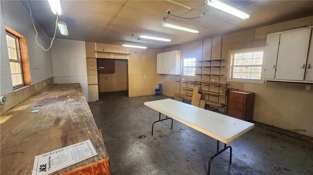 a kitchen with kitchen island a appliances wooden floor and wooden cabinets