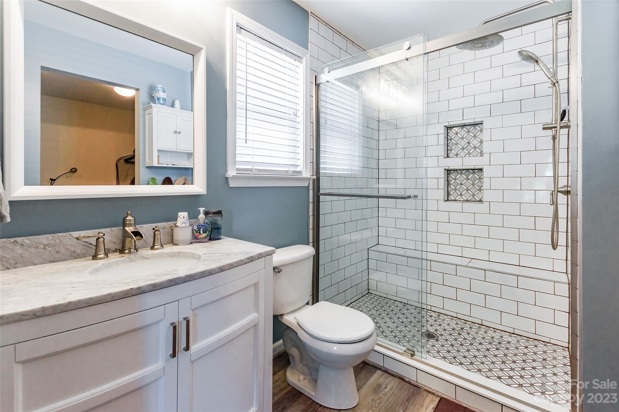 2210 Durand Road Fort Mill, SC 29715 - Photo 13 of 27 a bathroom with a granite countertop sink a toilet and shower