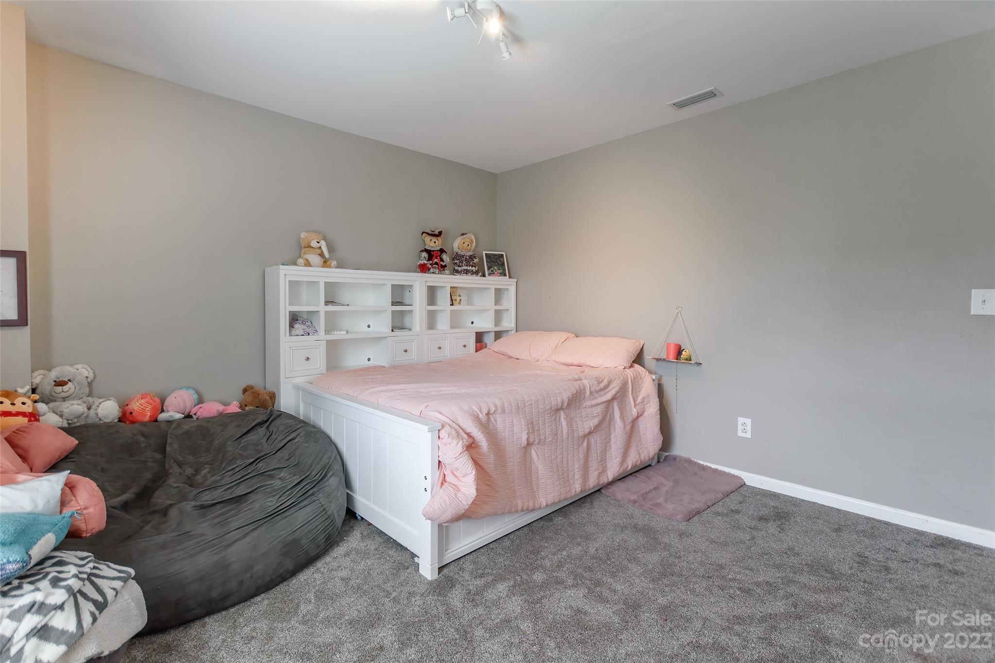 2210 Durand Road Fort Mill, SC 29715 - Photo 15 of 27 a bedroom with a bed and a chandelier