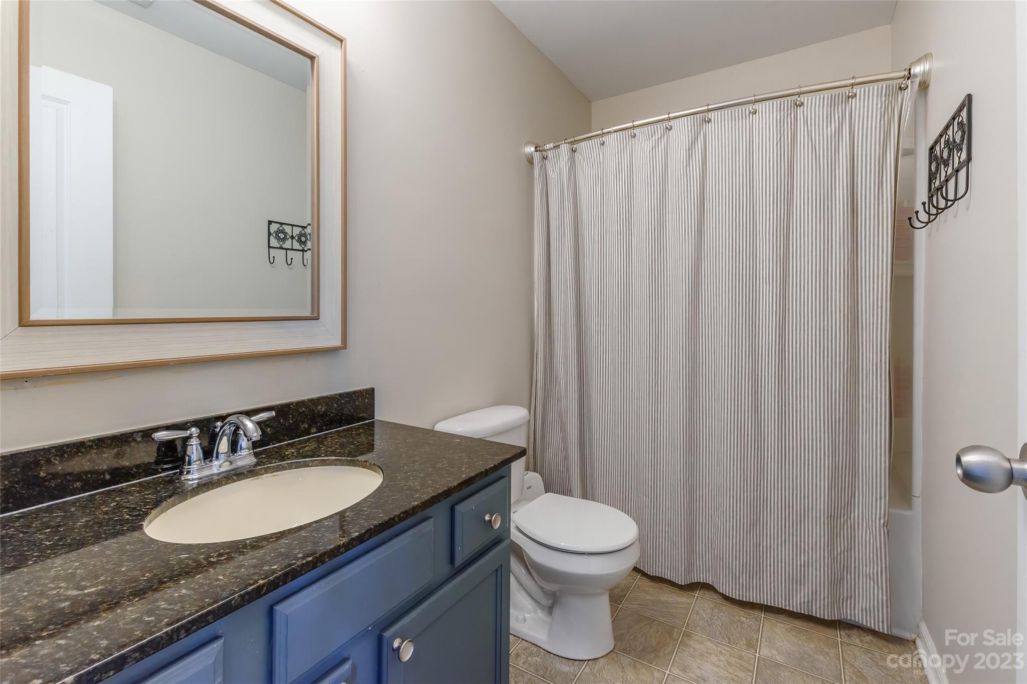 2210 Durand Road Fort Mill, SC 29715 - Photo 16 of 27 a bathroom with a granite countertop sink and a mirror
