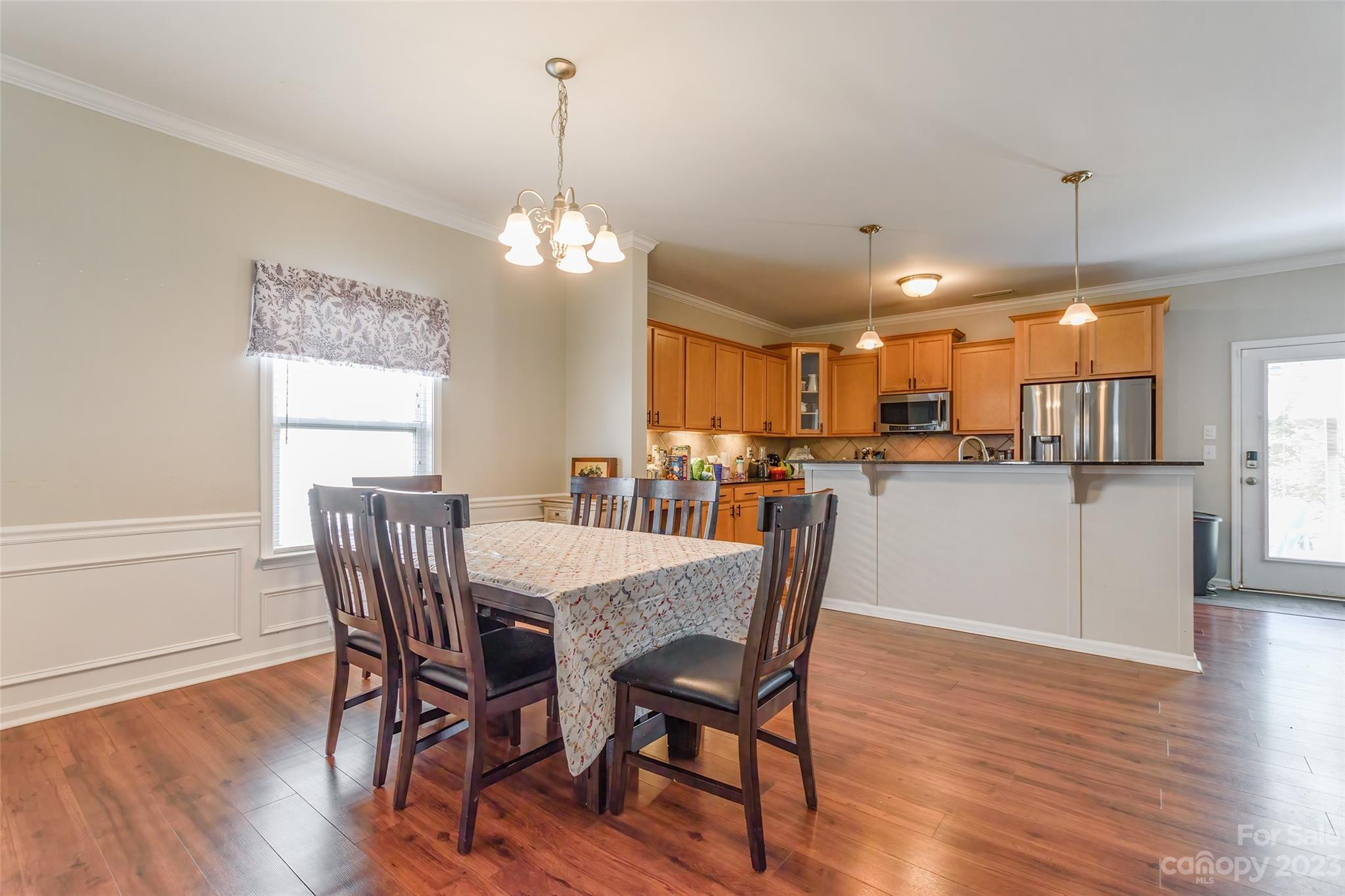 2210 Durand Road Fort Mill, SC 29715 - Photo 6 of 27 a view of a dining room and livingroom with furniture wooden floor a chandelier
