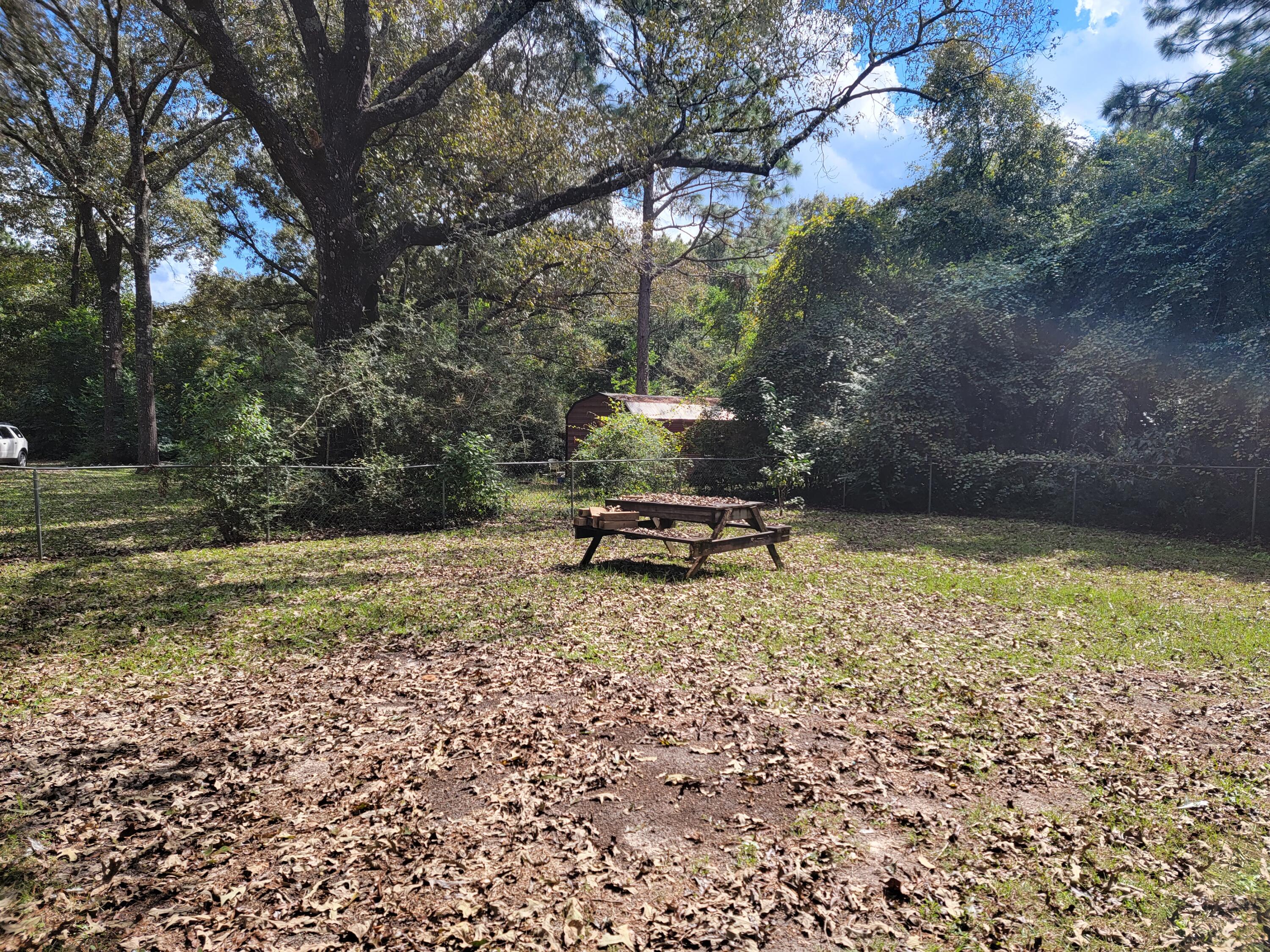 3542 Auburn Road Crestview, FL 32539 - Photo 14 of 14 a backyard of a house with a yard and outdoor seating