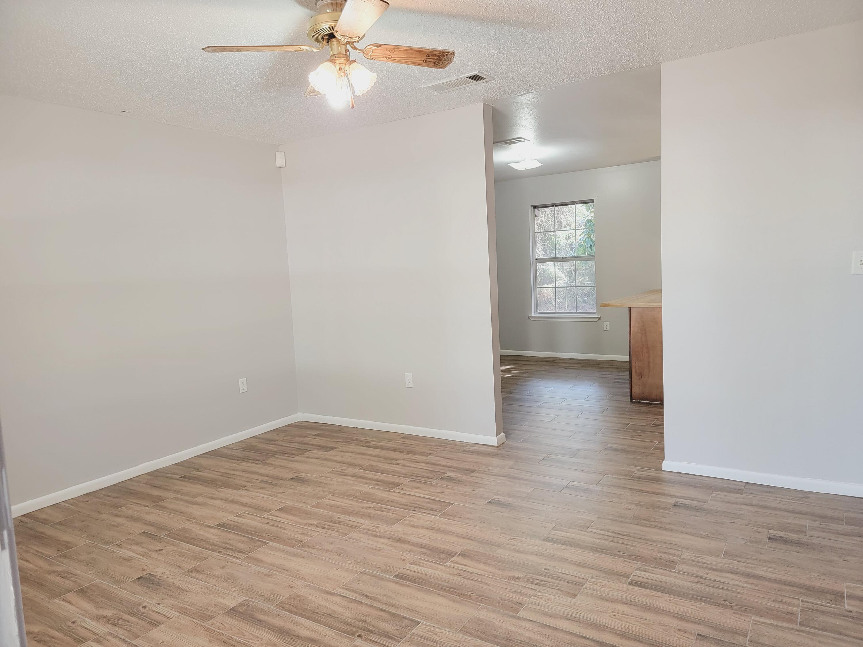 3542 Auburn Road Crestview, FL 32539 - Photo 3 of 14 wooden floor in an empty room