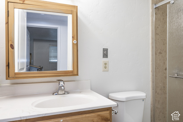 2727 Oneida Lane Provo, UT 84604 - Photo 18 of 26 Wood-framed medicine cabinet, integrated sink with chrome faucet, light-toned countertop, and shower enclosure with textured glass