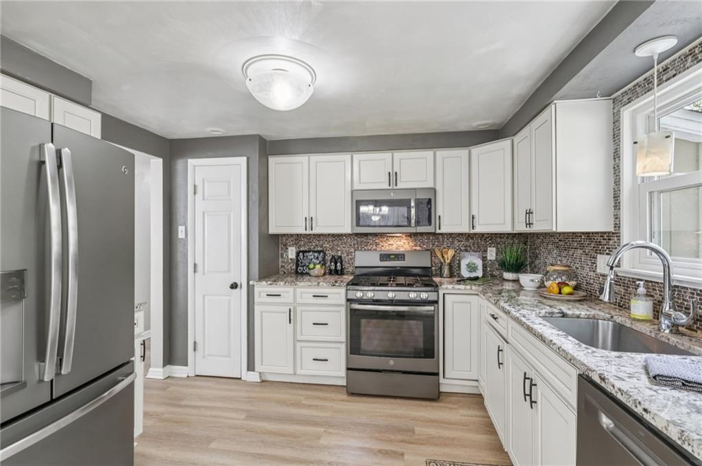 151 McIntyre Road Pittsburgh, PA 15237 - Photo 9 of 50 Updated kitchen with ivory cabinets, stainless steel appliances, granite countertops