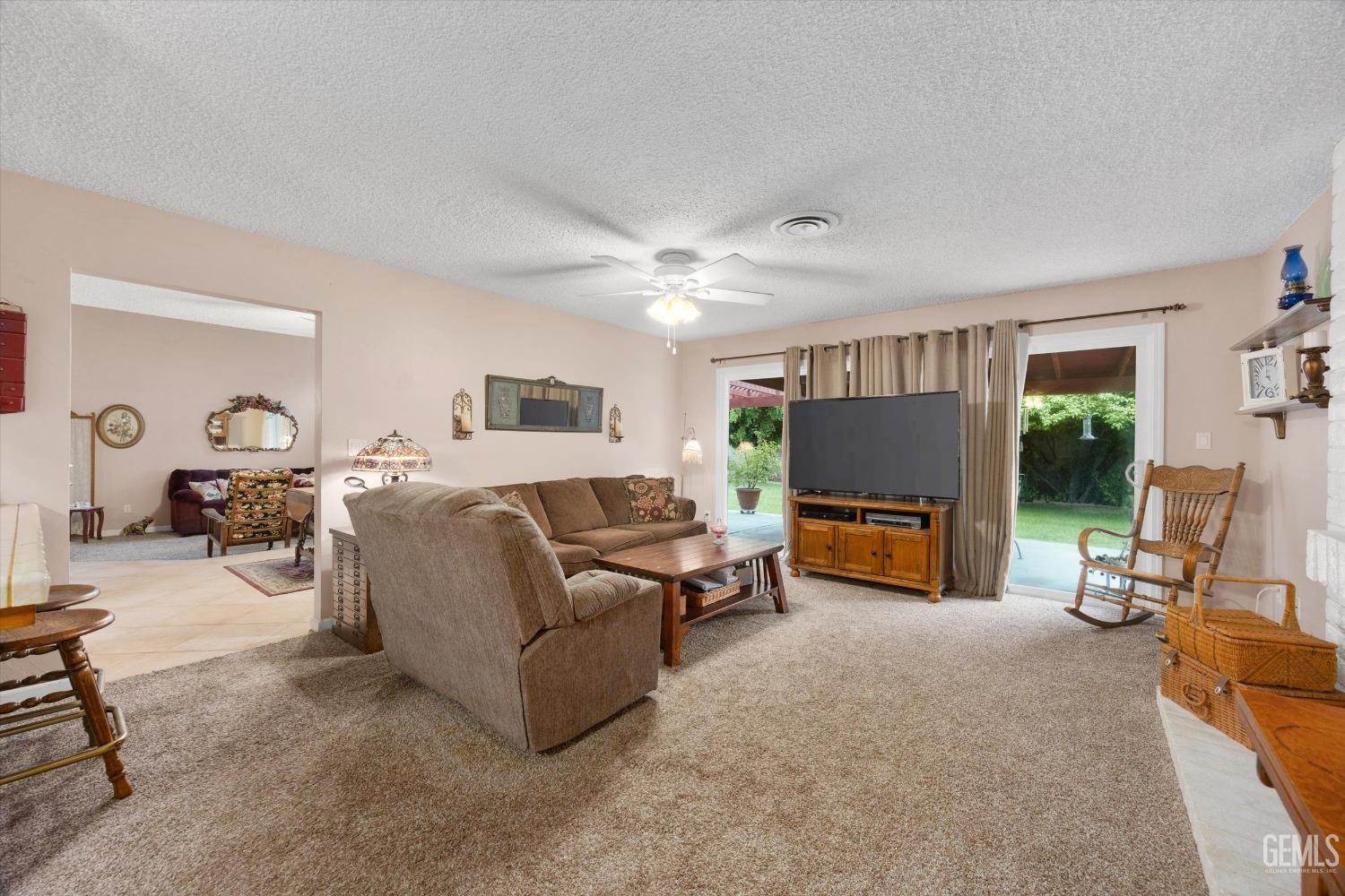 Undisclosed Address Bakersfield, CA 93309 - Photo 12 of 43 a living room with furniture and a flat screen tv