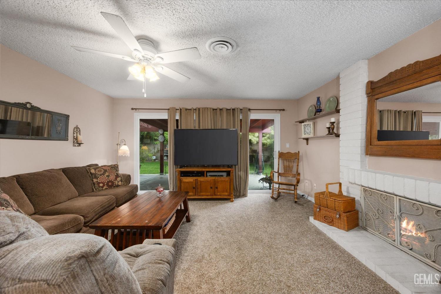 Undisclosed Address Bakersfield, CA 93309 - Photo 13 of 43 a living room with furniture and a flat screen tv