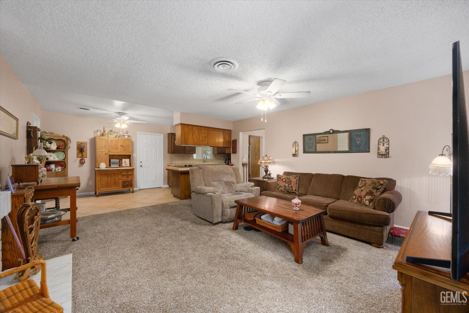 Undisclosed Address Bakersfield, CA 93309 - Photo 14 of 43 a living room with furniture and a flat screen tv
