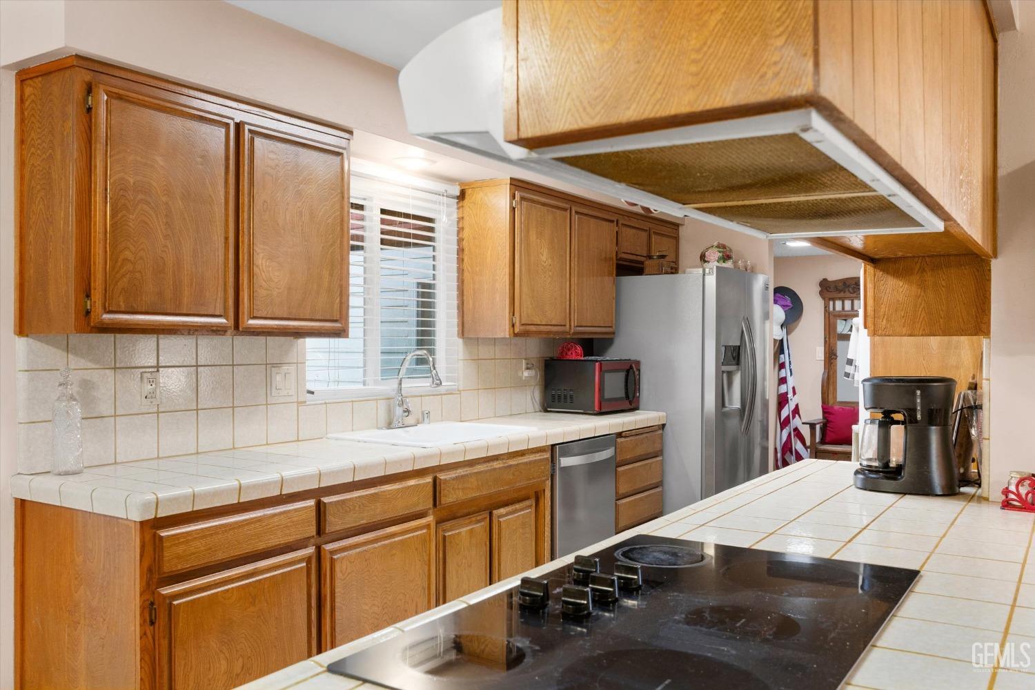 Undisclosed Address Bakersfield, CA 93309 - Photo 18 of 43 a kitchen with a sink cabinets and appliances