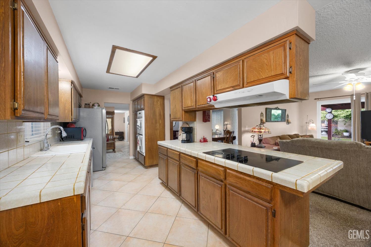 Undisclosed Address Bakersfield, CA 93309 - Photo 19 of 43 a kitchen with a sink and cabinets