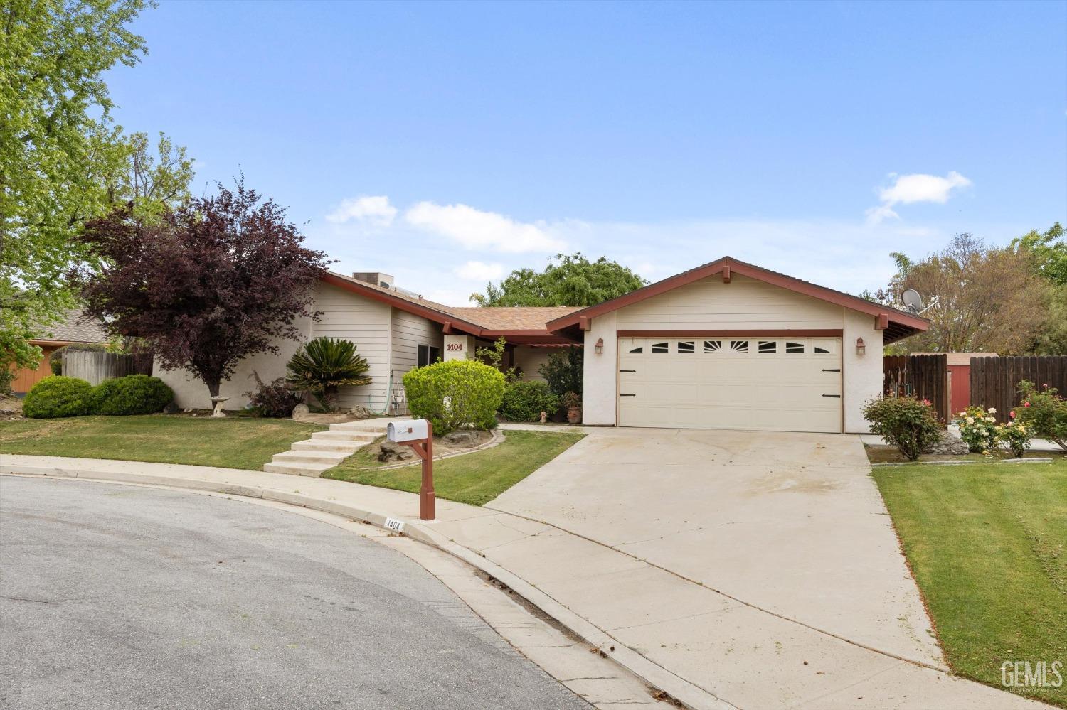 Undisclosed Address Bakersfield, CA 93309 - Photo 2 of 43 a view of a house with a yard and potted plants
