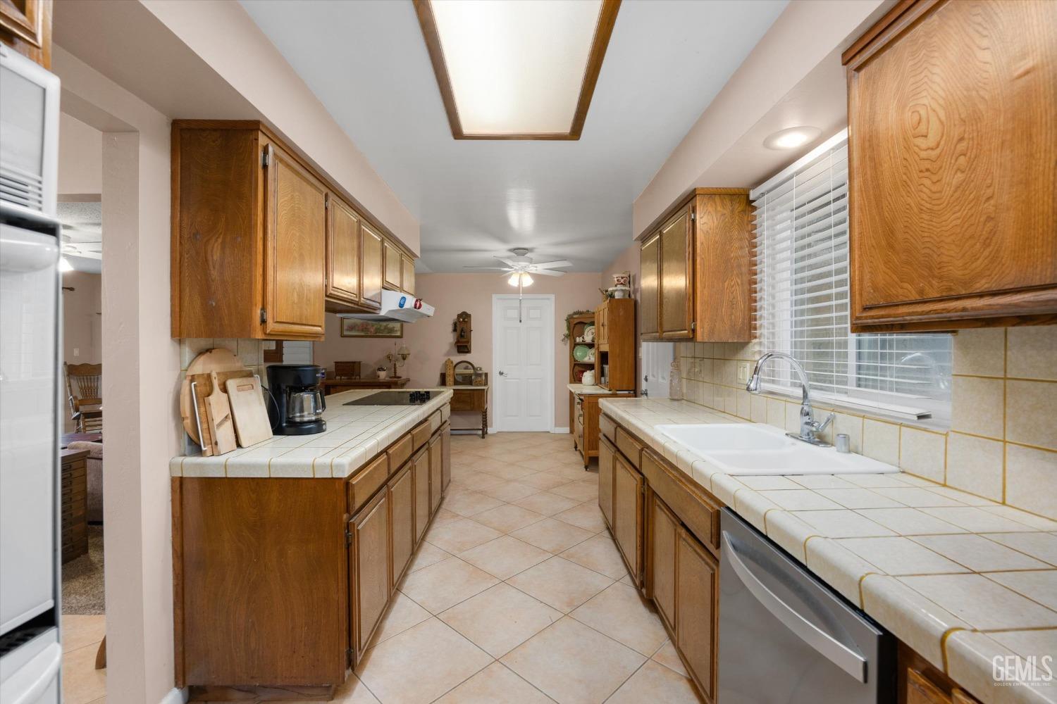 Undisclosed Address Bakersfield, CA 93309 - Photo 21 of 43 a kitchen with stainless steel appliances a sink stove and cabinets