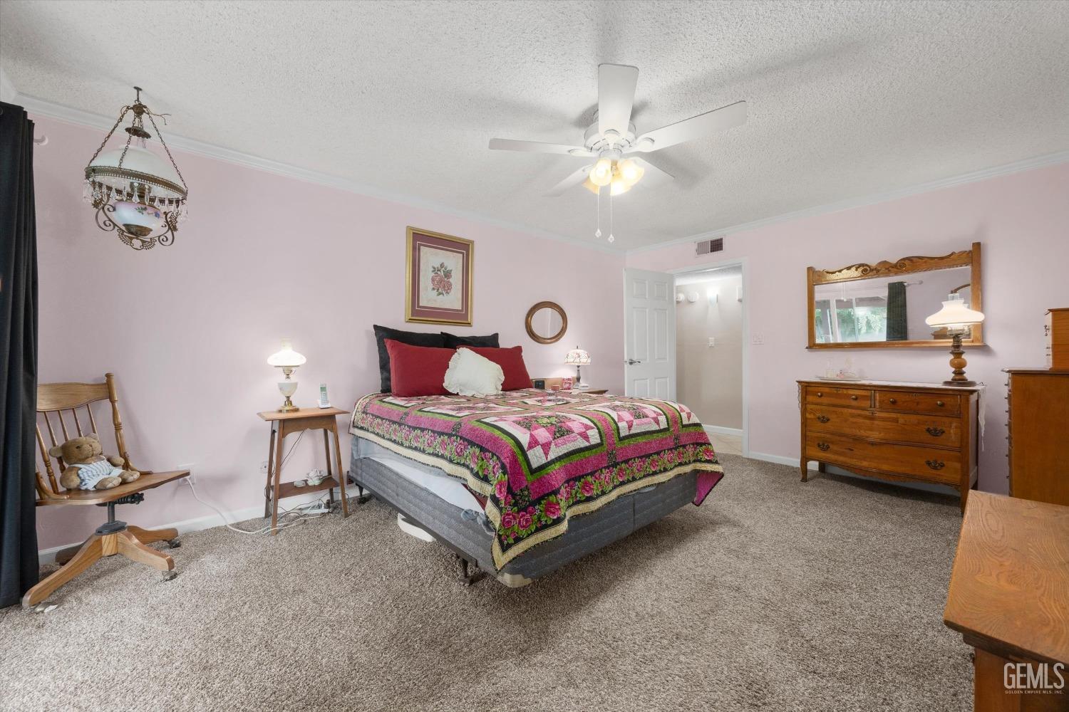 Undisclosed Address Bakersfield, CA 93309 - Photo 23 of 43 a bedroom with a bed a dresser and chair