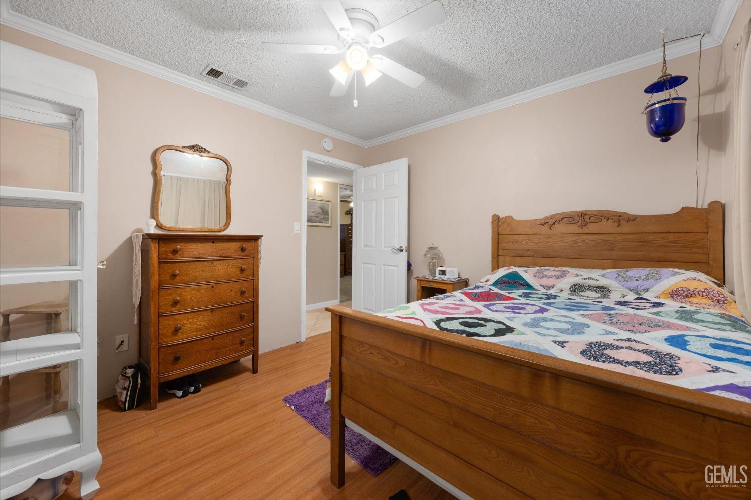 Undisclosed Address Bakersfield, CA 93309 - Photo 27 of 43 a bedroom with a bed and a dresser