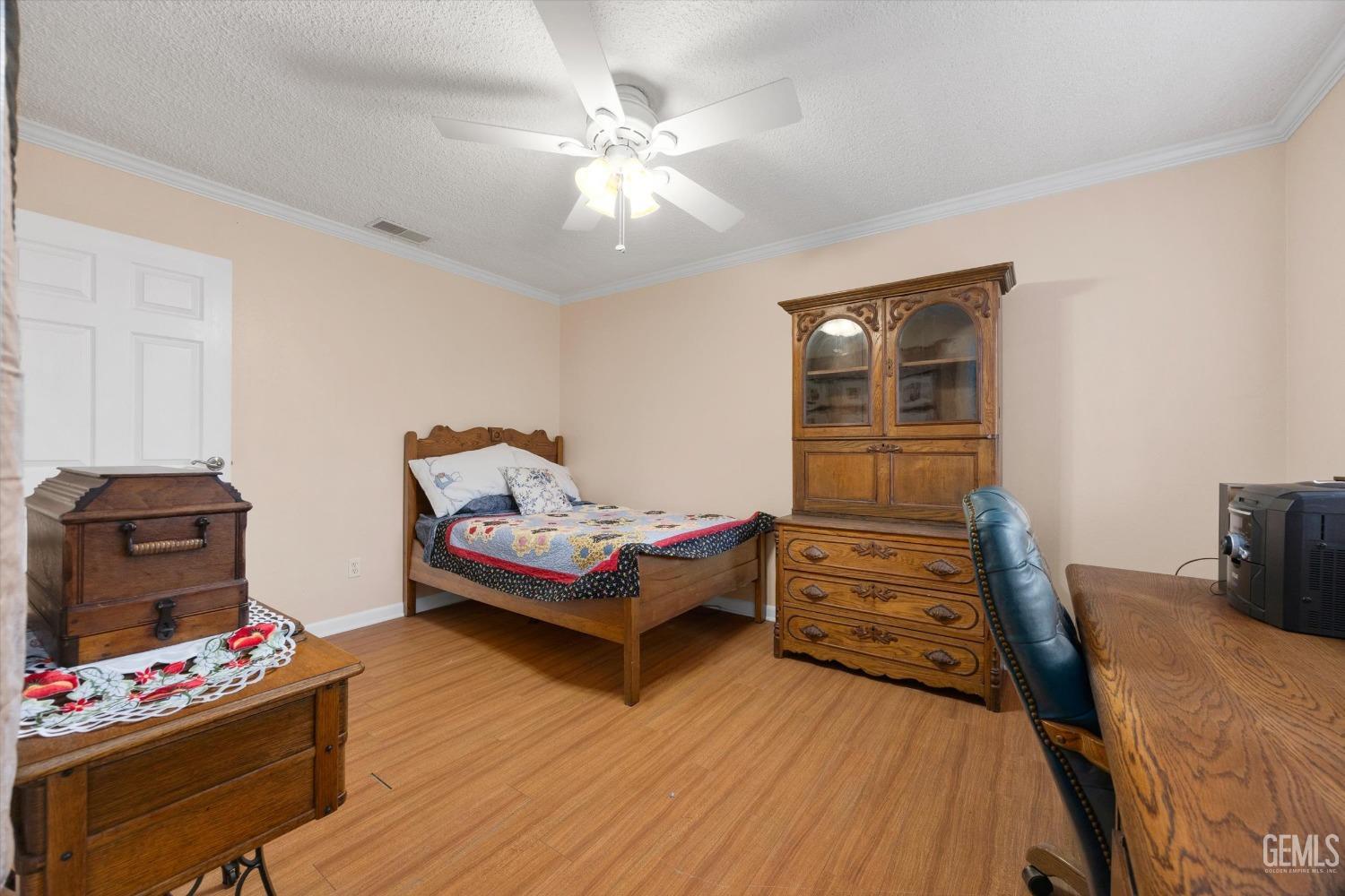 Undisclosed Address Bakersfield, CA 93309 - Photo 30 of 43 a bedroom with furniture and a wooden floor