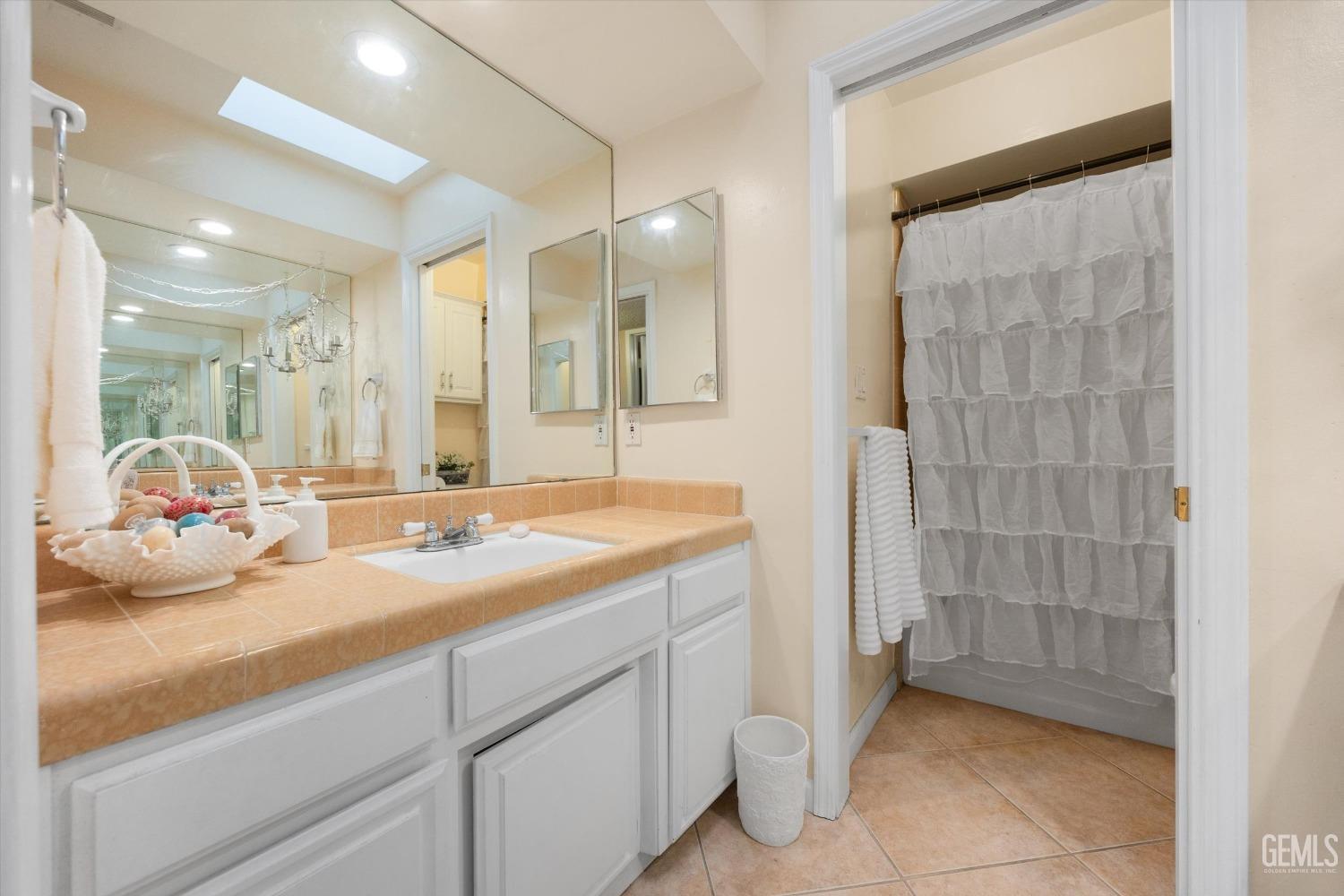 Undisclosed Address Bakersfield, CA 93309 - Photo 31 of 43 a bathroom with a sink and a mirror