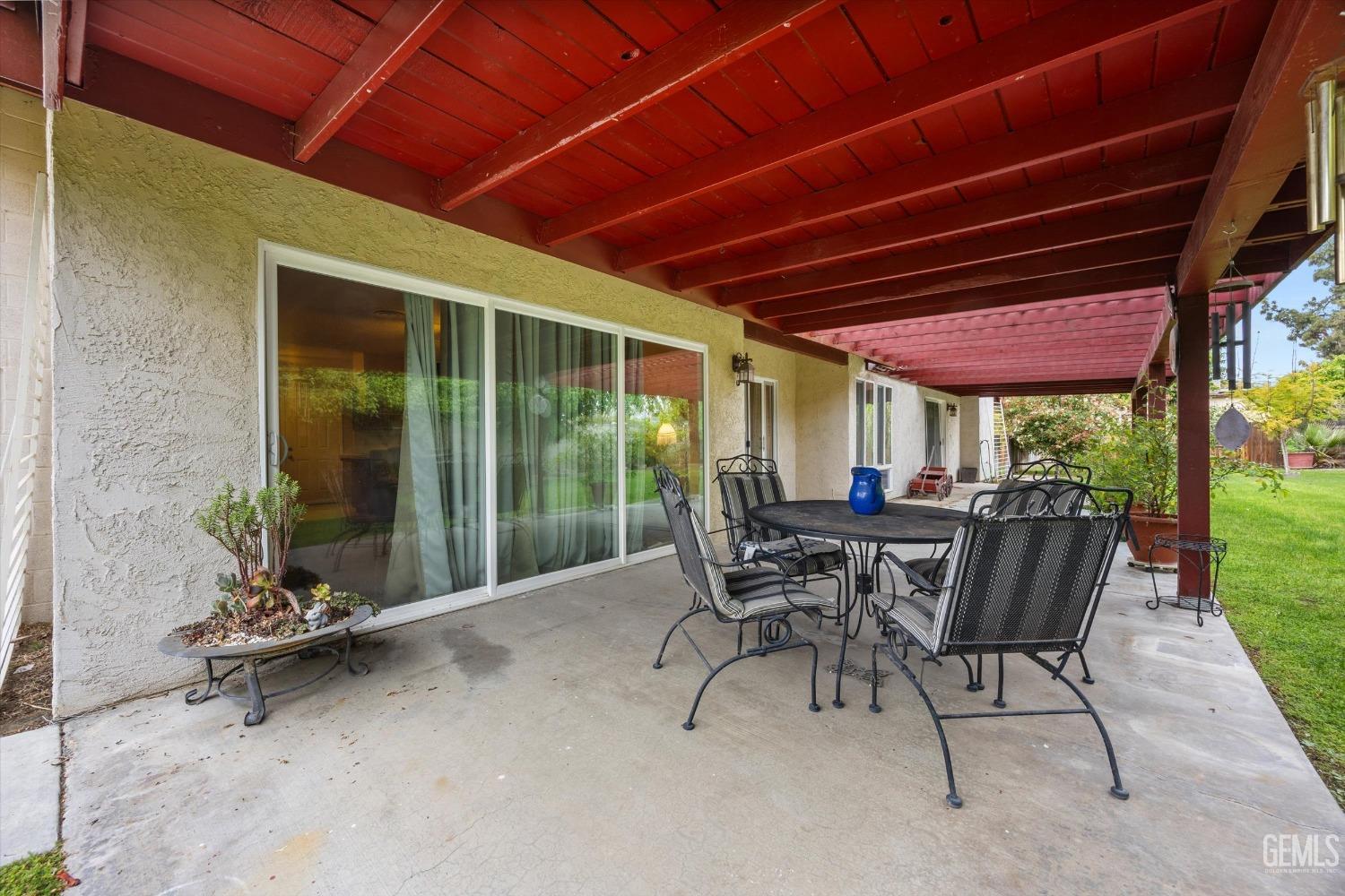 Undisclosed Address Bakersfield, CA 93309 - Photo 36 of 43 a view of a patio with a table and chairs under an umbrella
