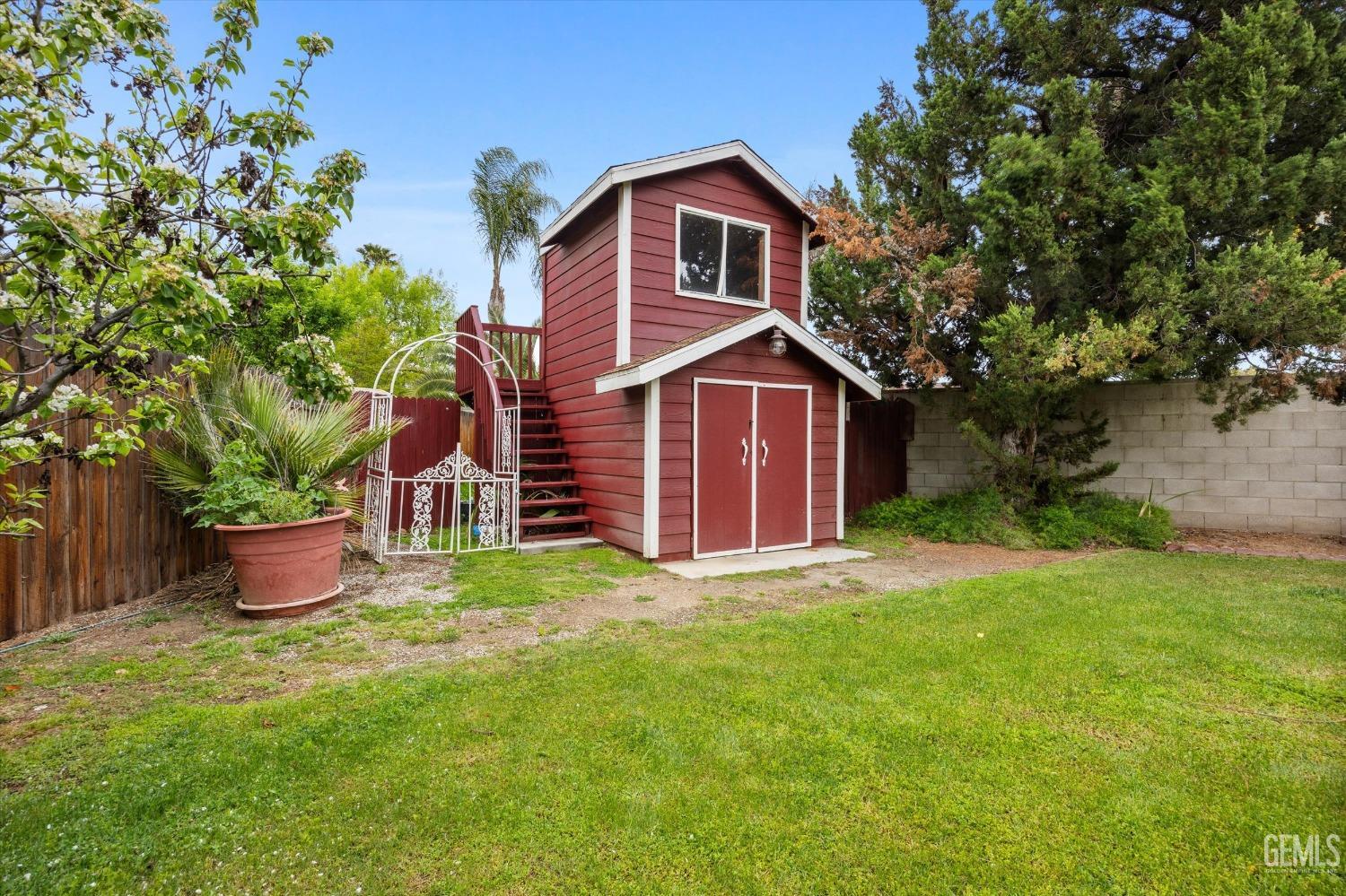 Undisclosed Address Bakersfield, CA 93309 - Photo 39 of 43 a front view of a house with a garden