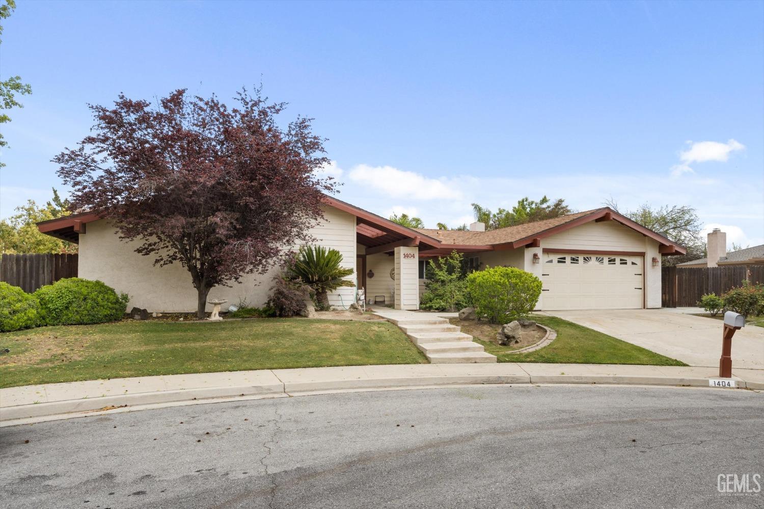 Undisclosed Address Bakersfield, CA 93309 - Photo 4 of 43 a front view of a house with a garden and yard