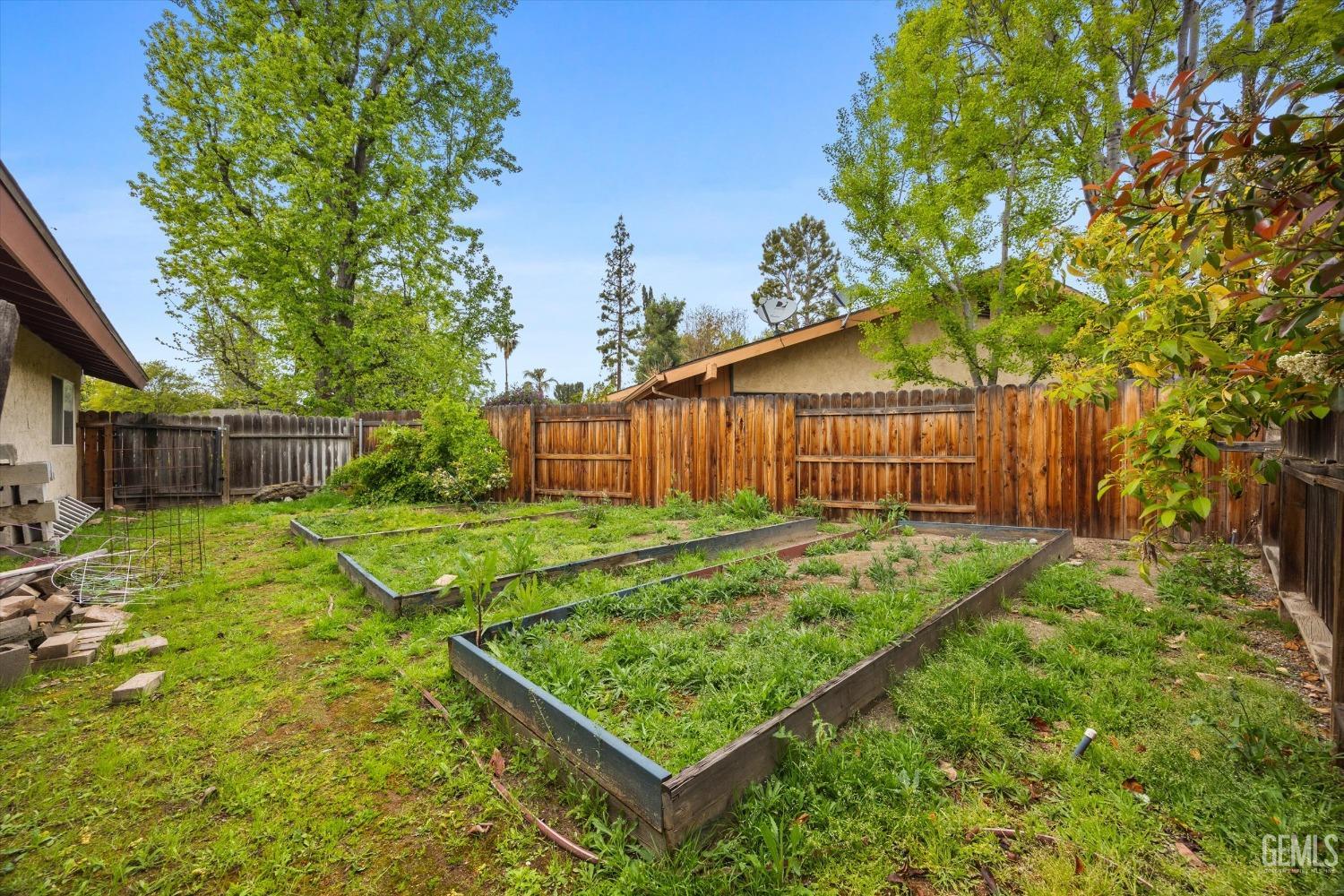 Undisclosed Address Bakersfield, CA 93309 - Photo 41 of 43 a view of a backyard with a small cabin and wooden fence