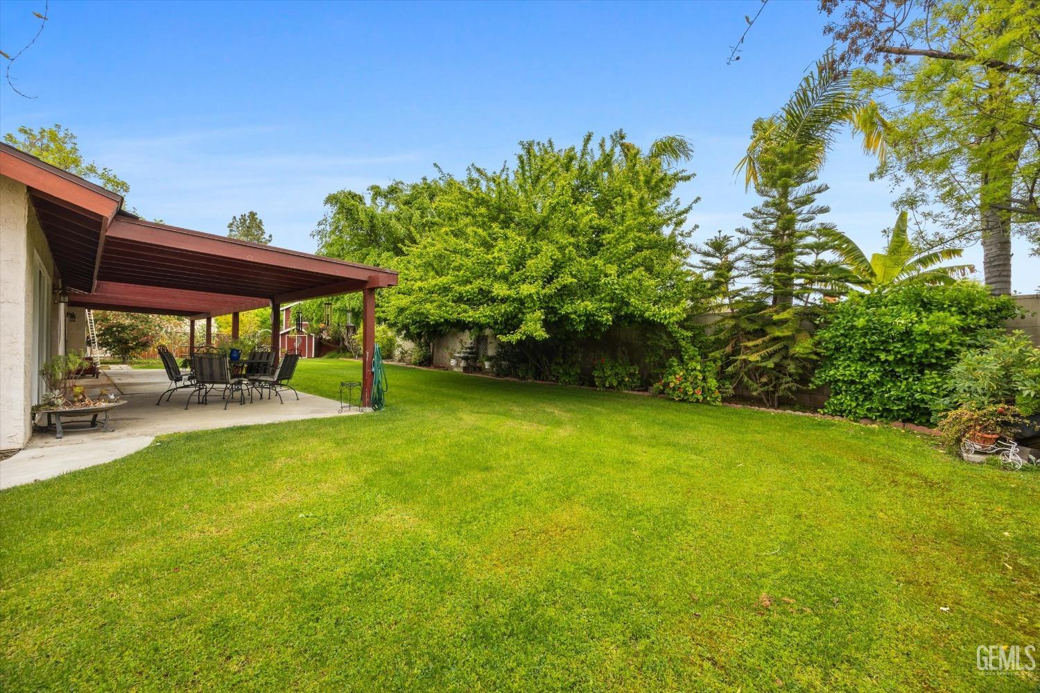 Undisclosed Address Bakersfield, CA 93309 - Photo 43 of 43 a view of a patio with table and chairs under an umbrella