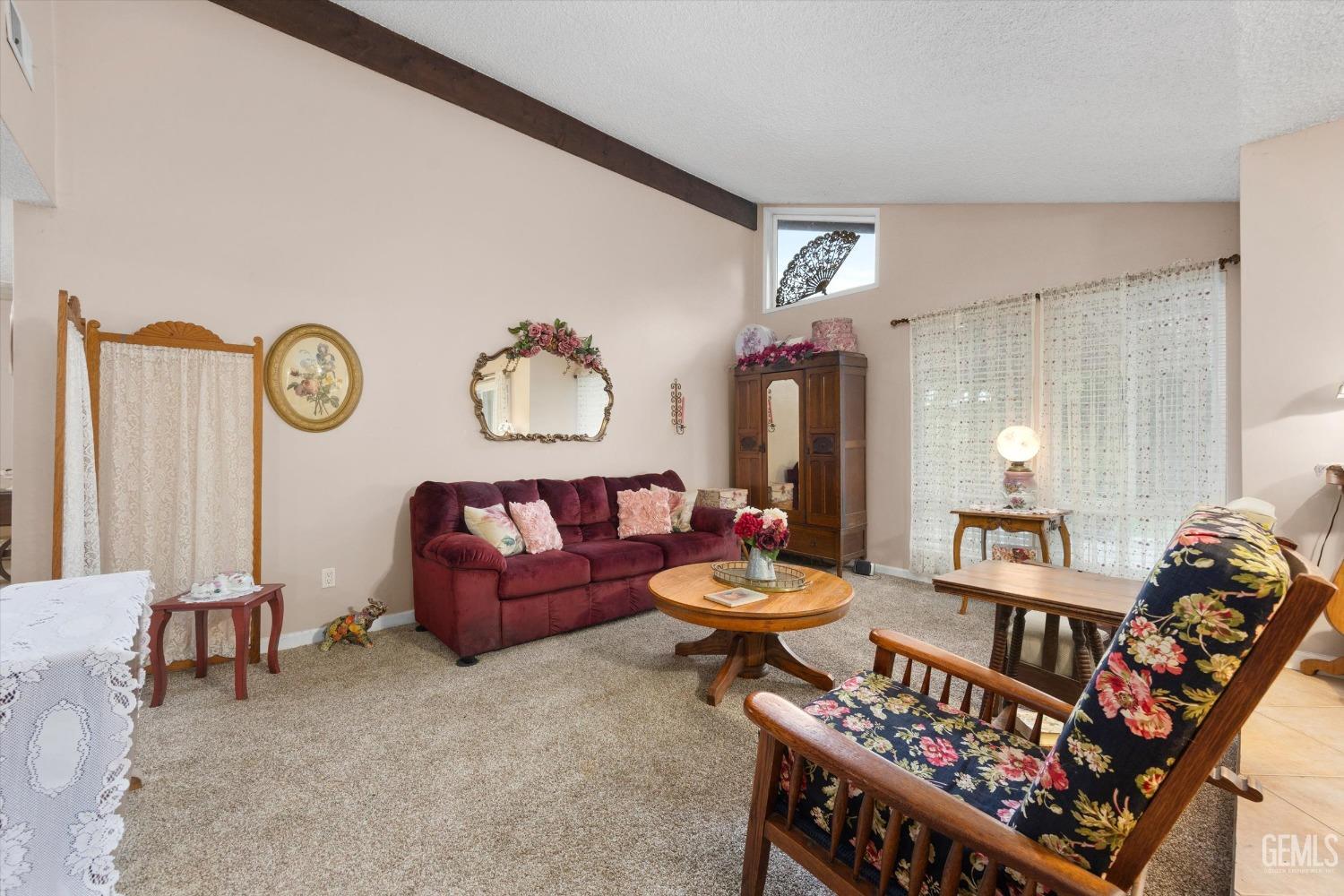 Undisclosed Address Bakersfield, CA 93309 - Photo 7 of 43 a living room with furniture a rug and a wall painting