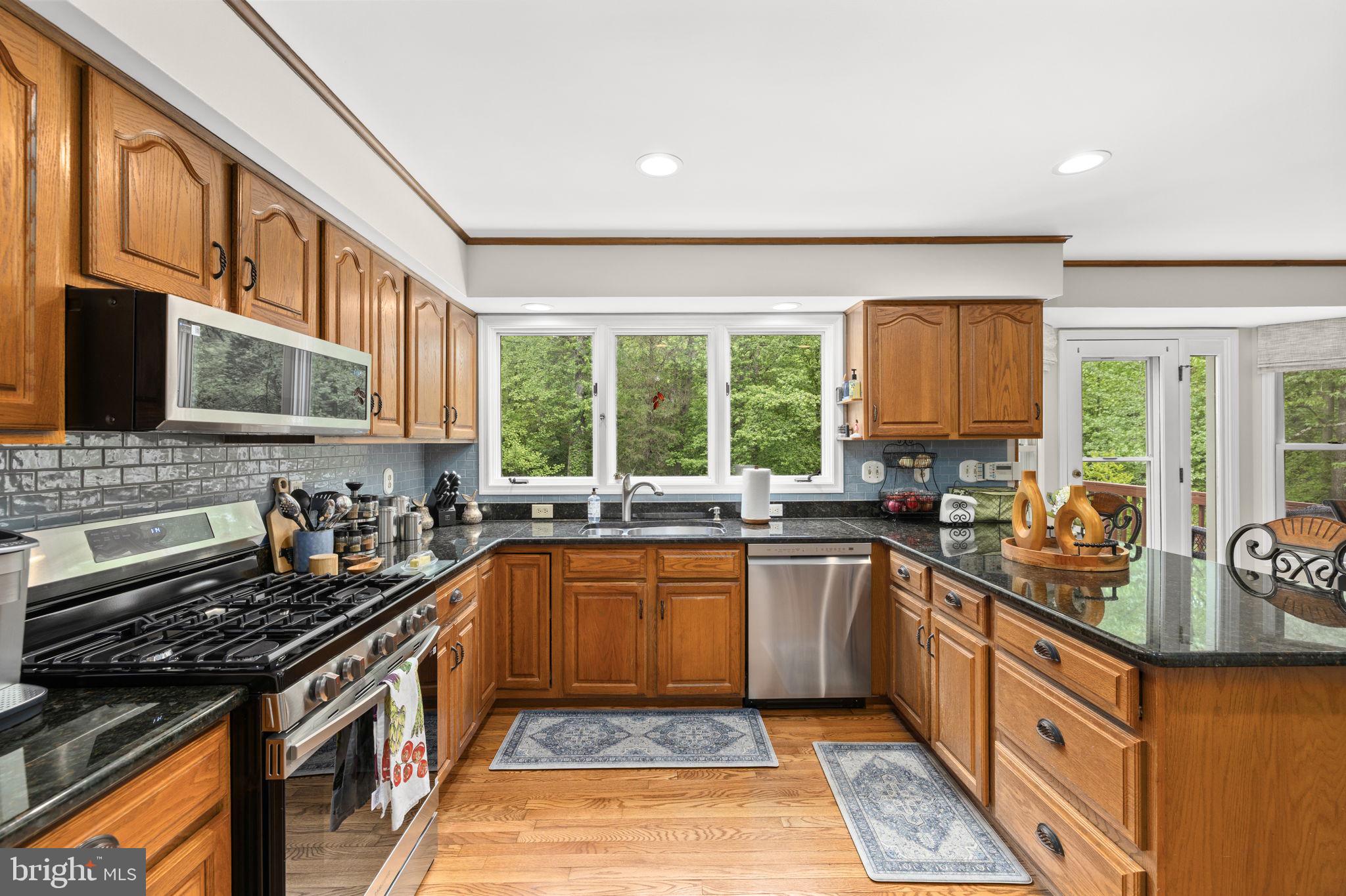 100 Boscobel Road Fredericksburg, VA 22405 - Photo 22 of 67 a kitchen with stainless steel appliances a sink stove and cabinets