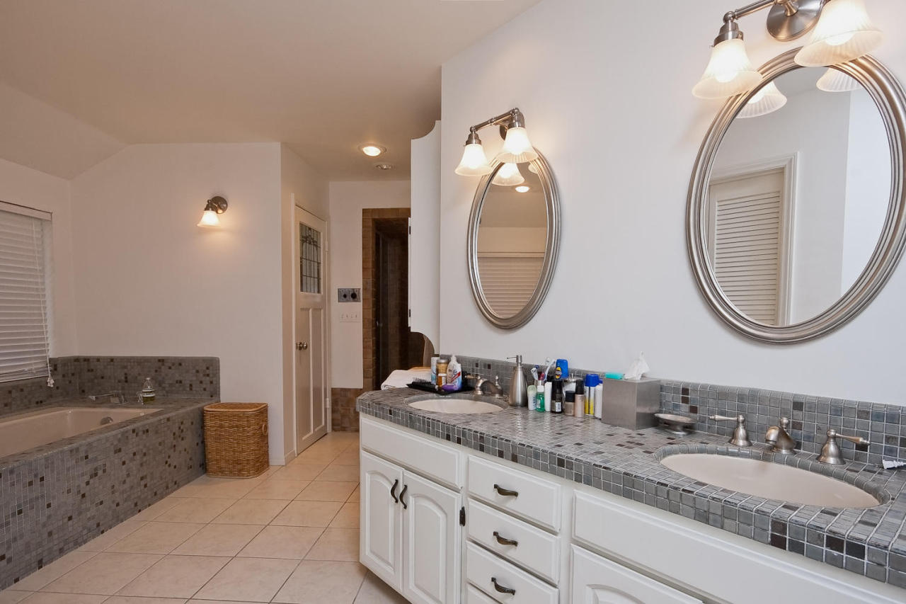 312 Fairview Road Ojai, CA 93023 - Photo 11 of 24 a en suite bathroom with a granite countertop double vanity sink and a mirror