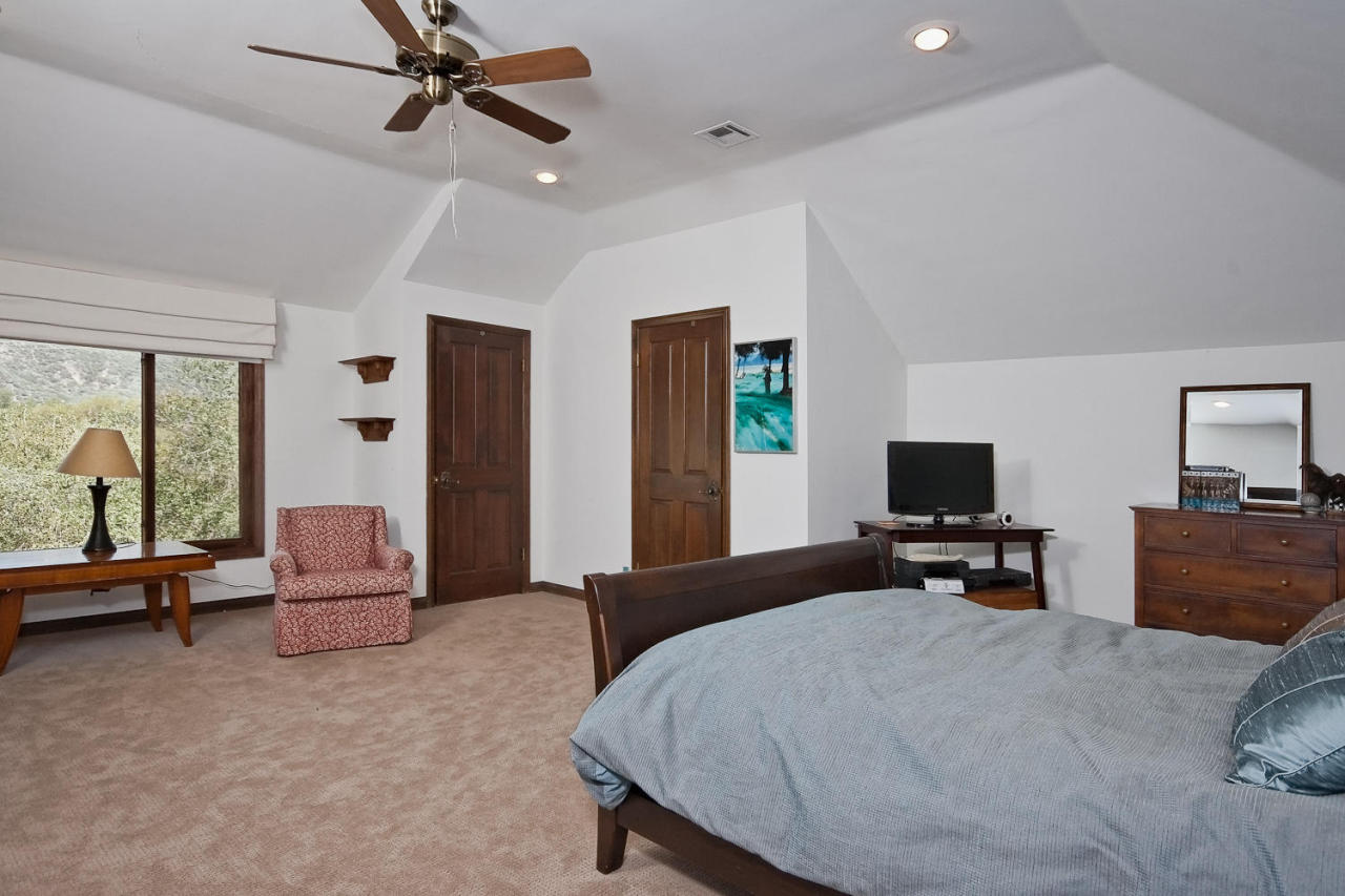 312 Fairview Road Ojai, CA 93023 - Photo 14 of 24 a bedroom with a bed and furniture