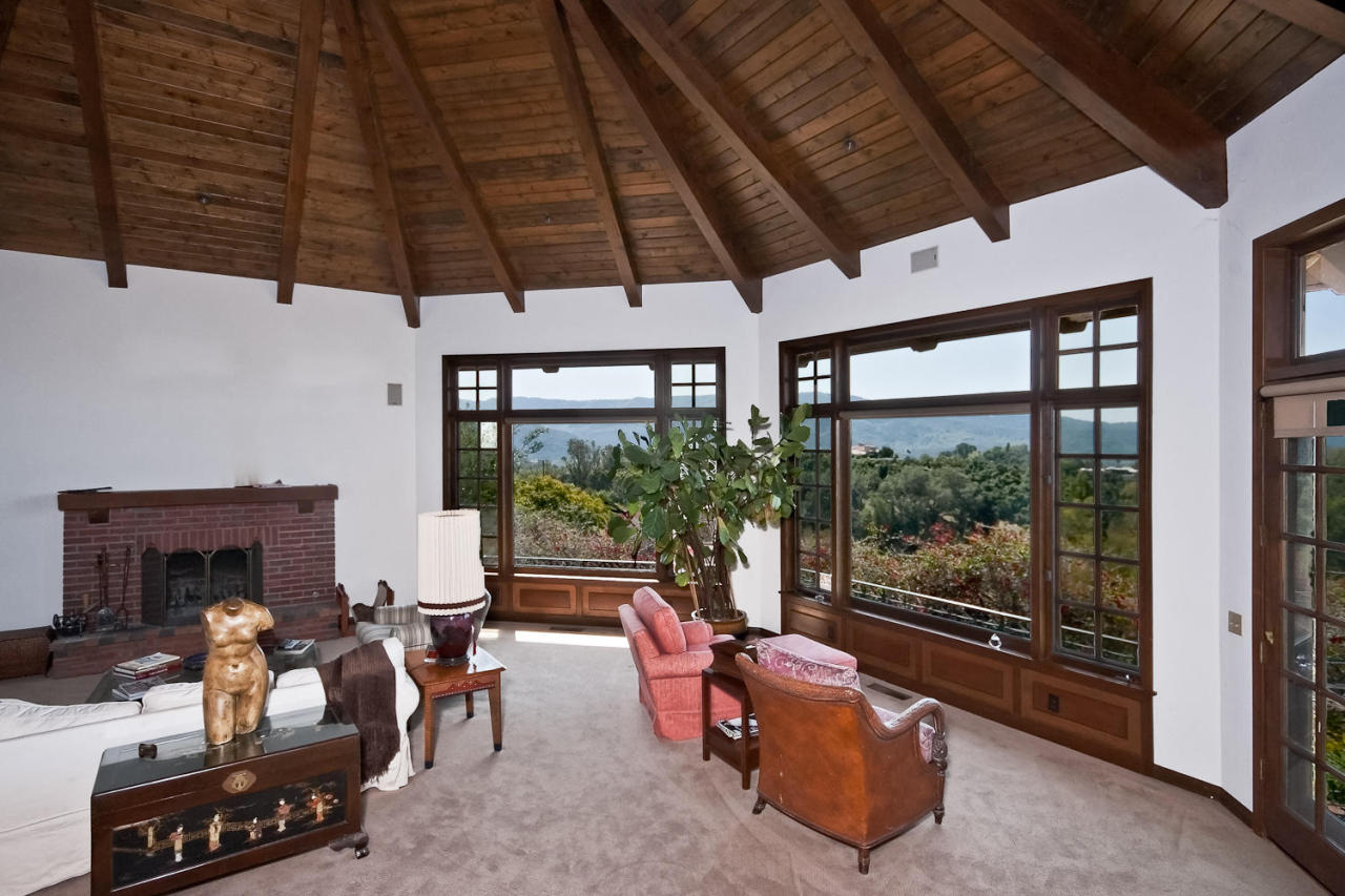 312 Fairview Road Ojai, CA 93023 - Photo 21 of 24 a living room with furniture a fireplace and a table