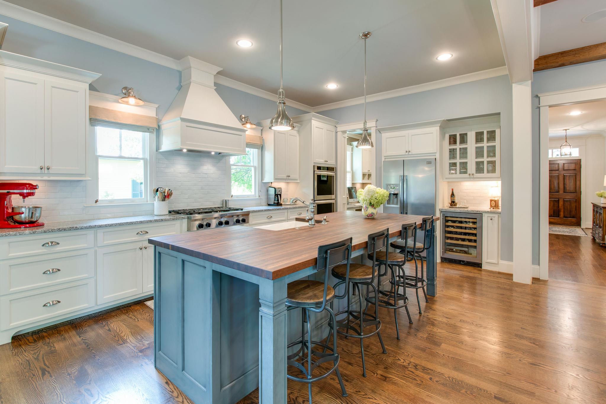 206 Franklin Road Franklin, TN 37064 - Photo 18 of 30 a kitchen with stainless steel appliances kitchen island granite countertop a table chairs sink and cabinets