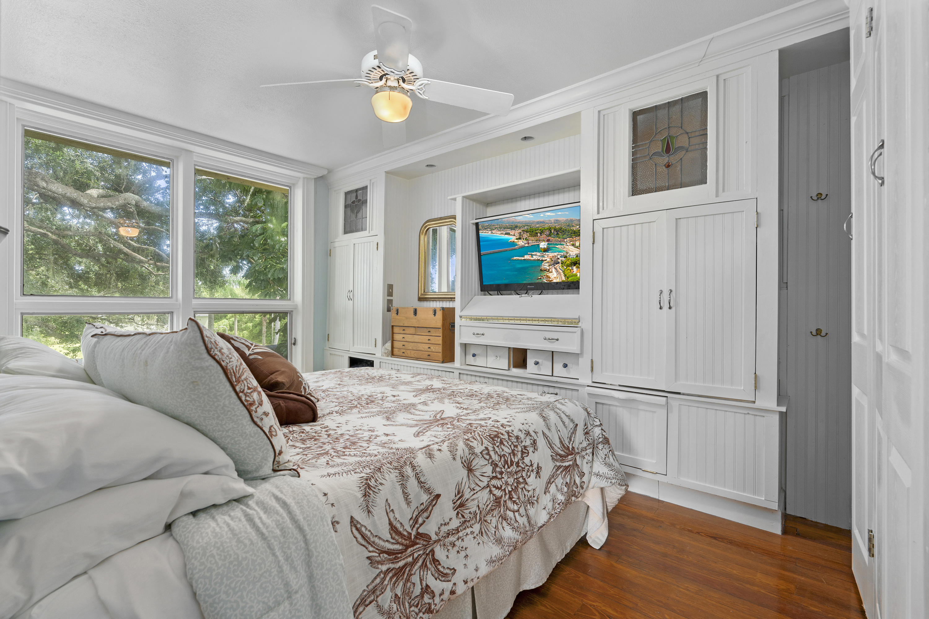4098 McCarty Road Fort Pierce, FL 34945 - Photo 13 of 38 a bedroom with a bed painting on wall and a large window