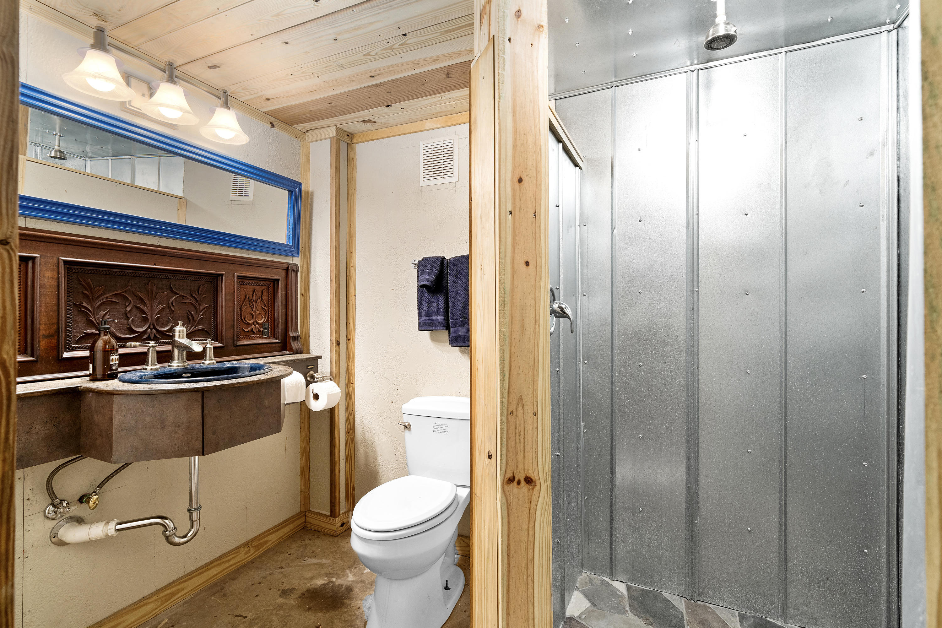4098 McCarty Road Fort Pierce, FL 34945 - Photo 32 of 38 a bathroom with a granite countertop shower a toilet and a sink
