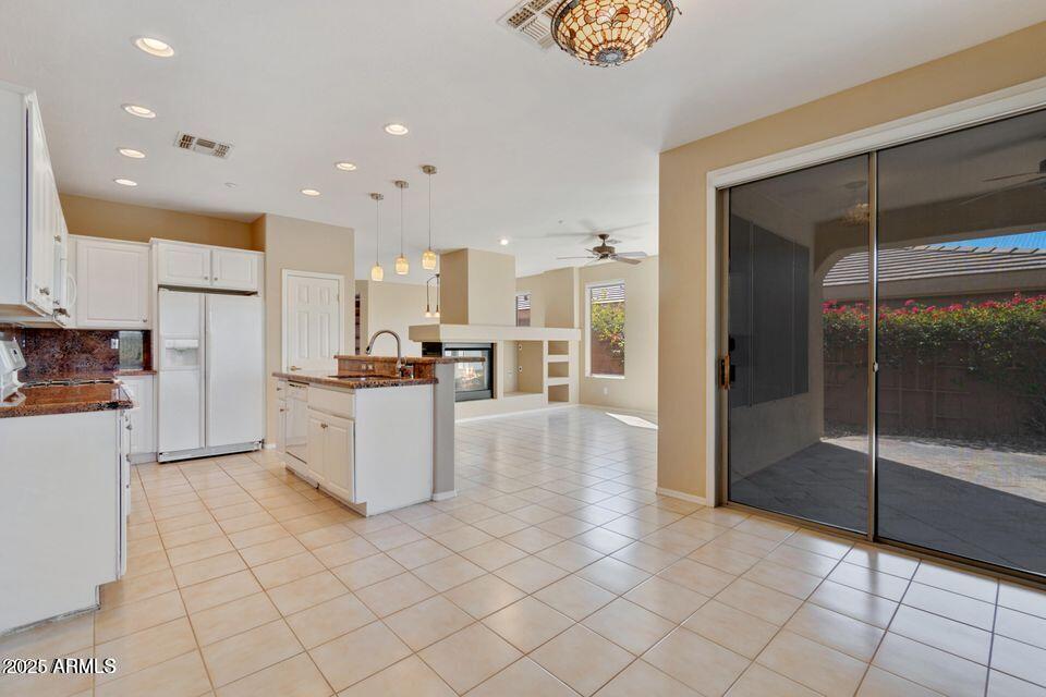 41526 North Cedar Chase Road Anthem, AZ 85086 - Photo 7 of 14 a kitchen with stainless steel appliances kitchen island granite countertop a refrigerator and a stove top oven