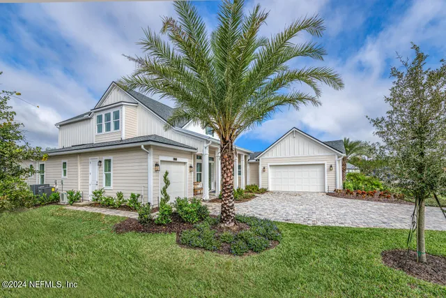 a house that has a tree in front of the house