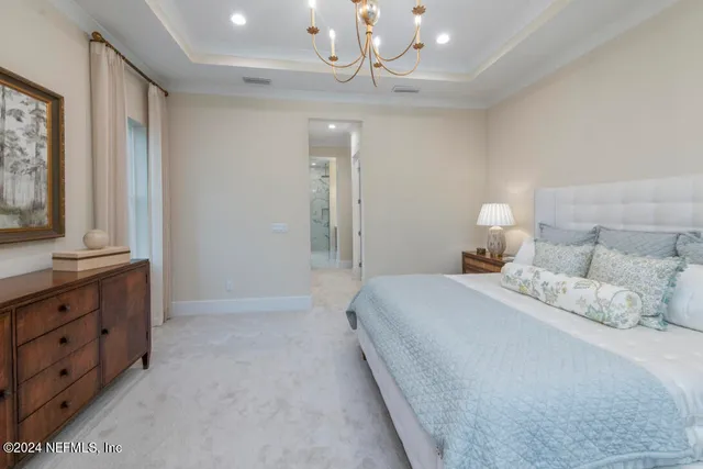 a bedroom with a bed and a lamp