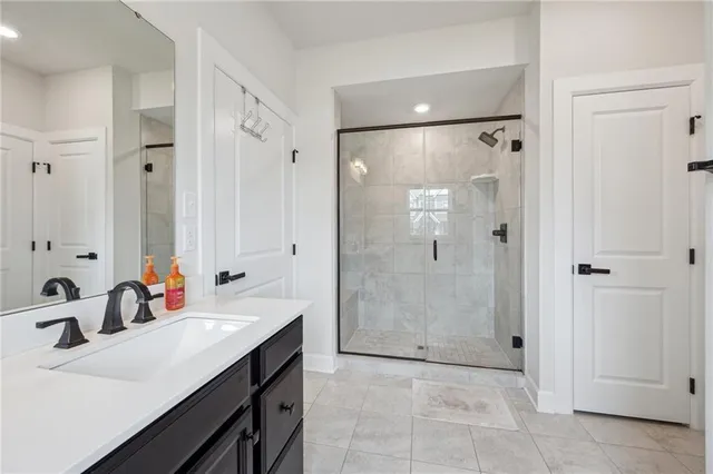 a bathroom with a tub sink mirror and shower