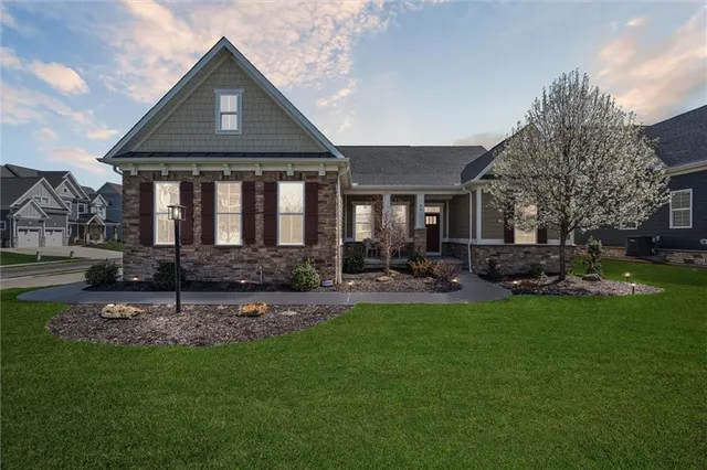 a front view of house with yard and outdoor seating