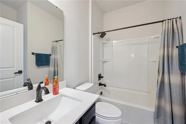 a bathroom with a sink a toilet and a bathtub