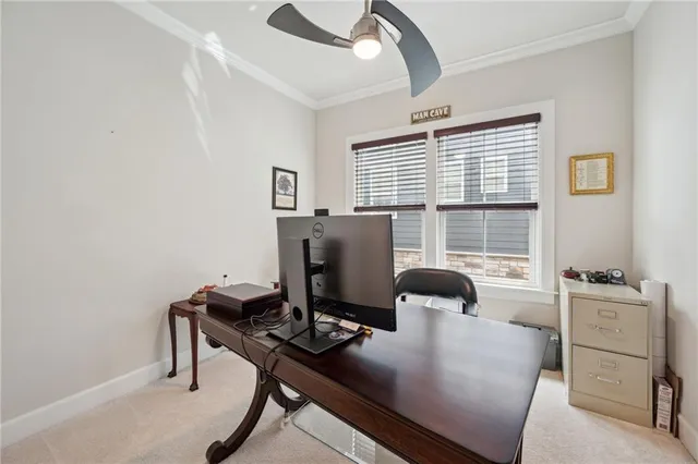 a view of a workspace with furniture and a window
