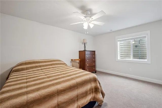 a bedroom with a bed and ceiling fan