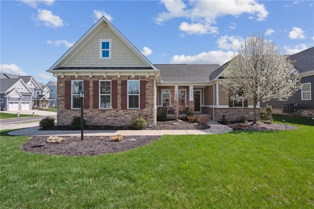 a front view of a house with swimming pool and garden
