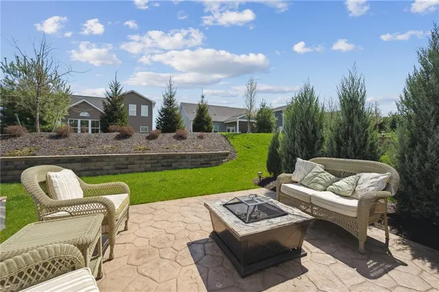 a view of a white couches with a backyard