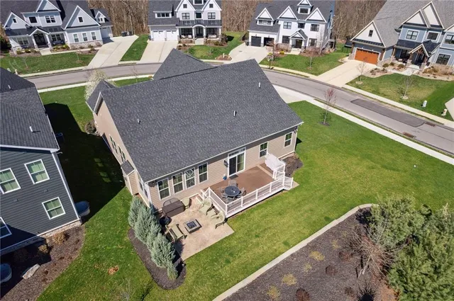 an aerial view of a house with a garden and swimming pool