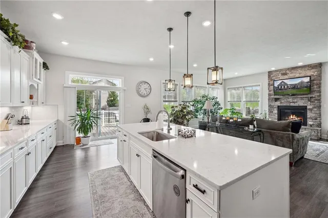 an open kitchen with a sink stove and cabinets