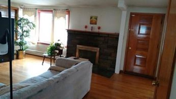 157 Bemis Road Holyoke, MA 01040 - Photo 3 of 6 a living room with furniture and a fireplace