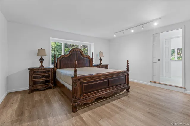 a bed room with a bed and wooden floor