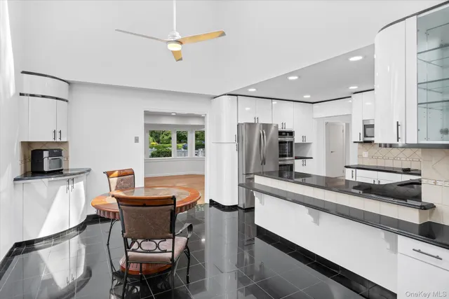 a view of a dining room with furniture and a chandelier