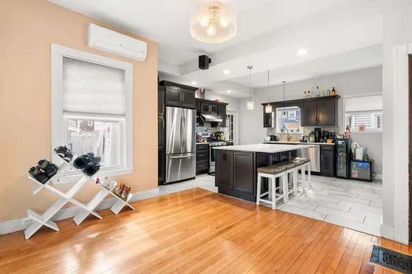 a kitchen with stainless steel appliances kitchen island granite countertop a refrigerator and a sink