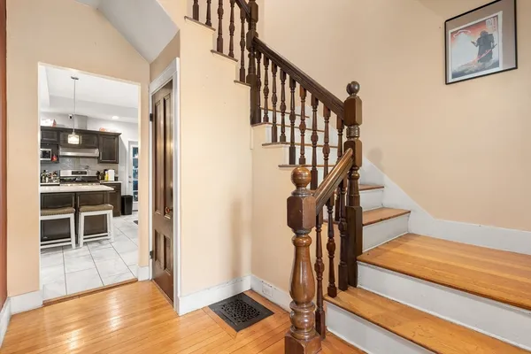 a view of entryway and hall with wooden floor
